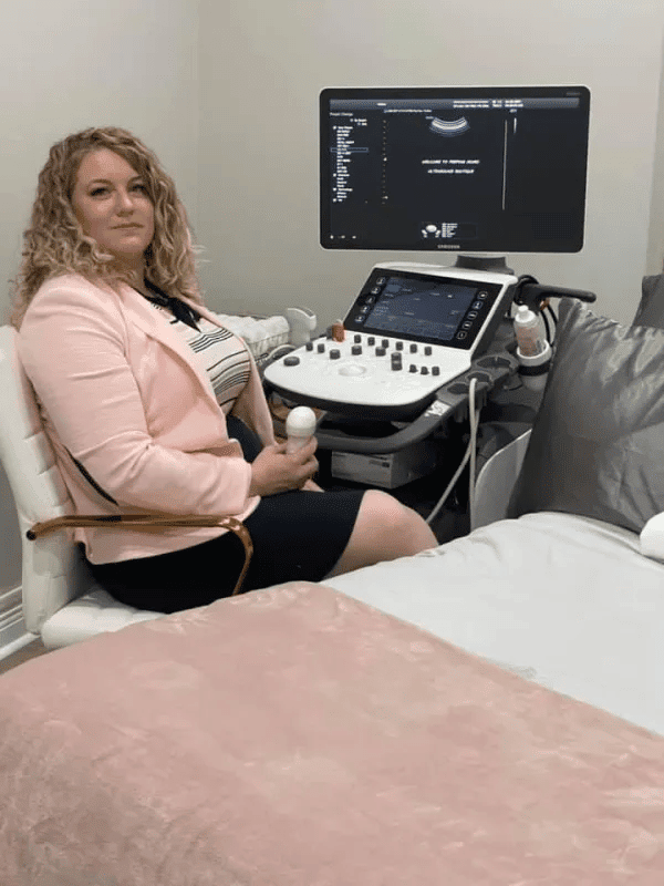Ultrasound technologist sitting at a Samsung WS80A Elite ultrasound machine